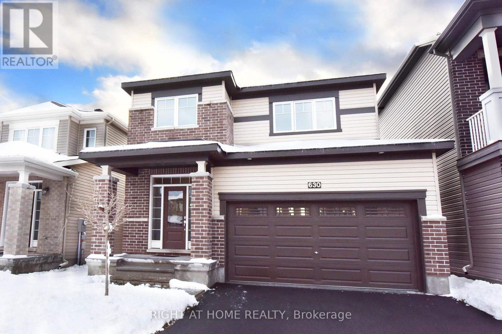 A house with a brown garage door is for sale in Brokerage.