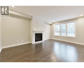 A spacious room with a fireplace and a large window.