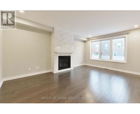 A spacious room with a fireplace and a large window.