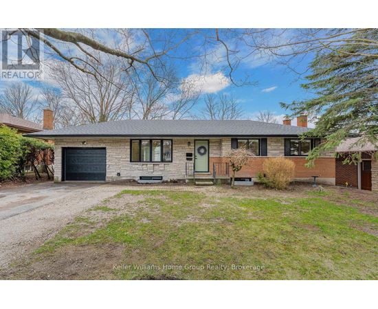 A house with a grey roof and a green door is for sale.