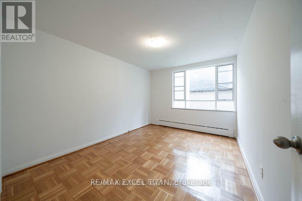 A room with a wooden floor and a window.