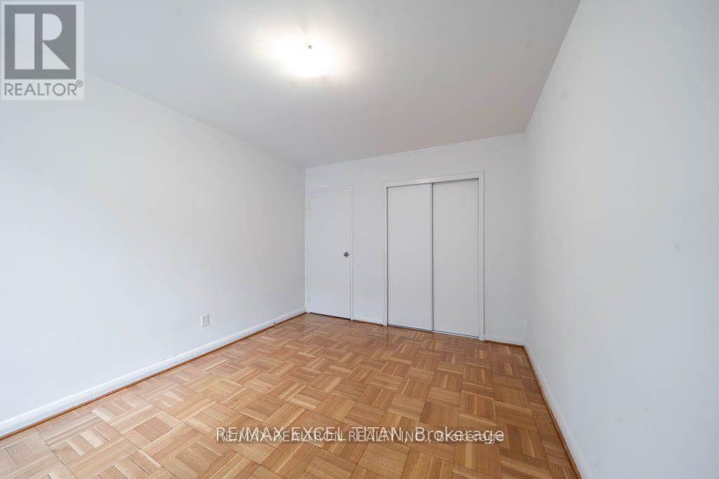 A room with a wooden floor and a white door.