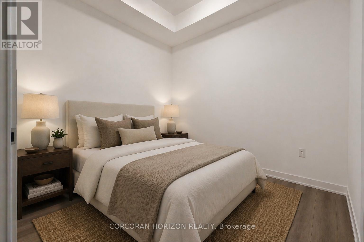A bedroom with a large bed and two lamps on either side of the bed.