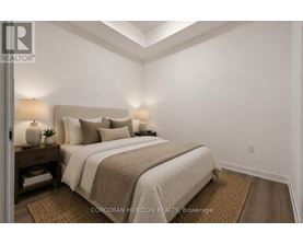 A bedroom with a large bed and two lamps on either side of the bed.