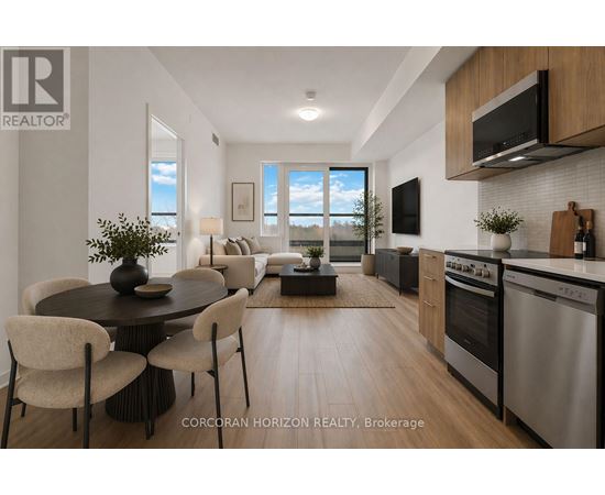 A modern kitchen with stainless steel appliances and a dining table with chairs.