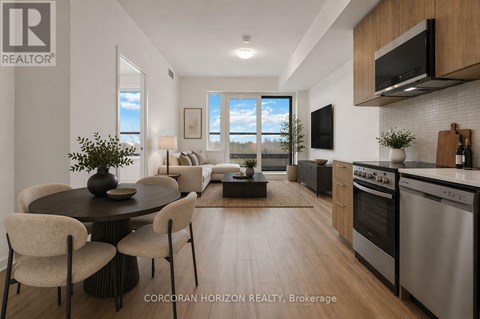 A modern kitchen with stainless steel appliances and a dining table with chairs.