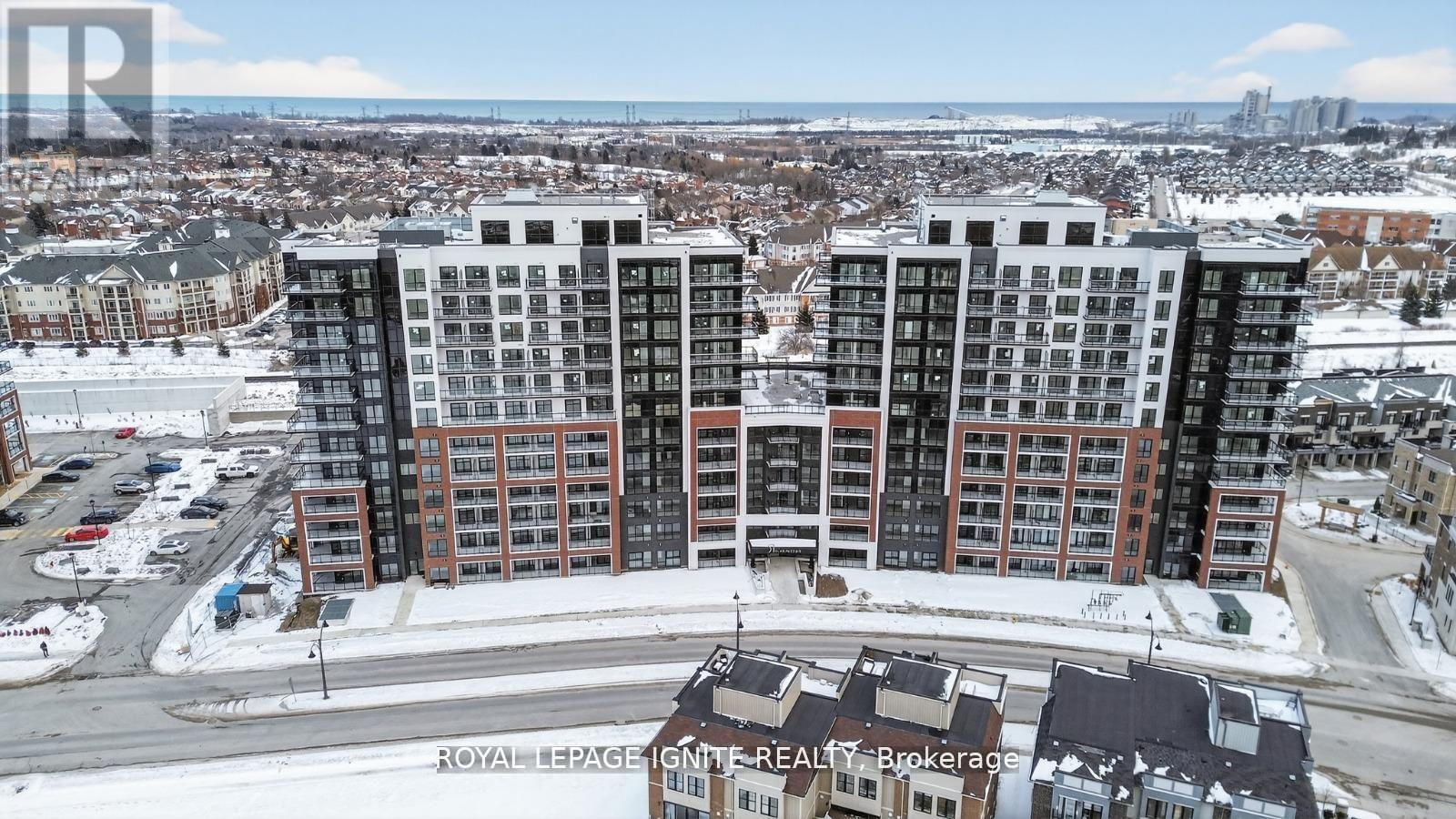 A large apartment complex is surrounded by a snowy landscape.