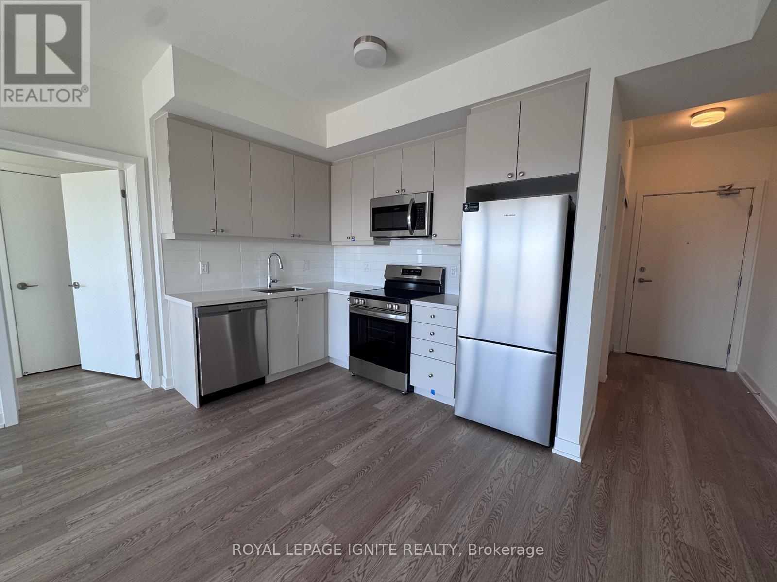 A kitchen with white cabinets and stainless steel appliances.