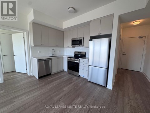 A kitchen with white cabinets and stainless steel appliances.