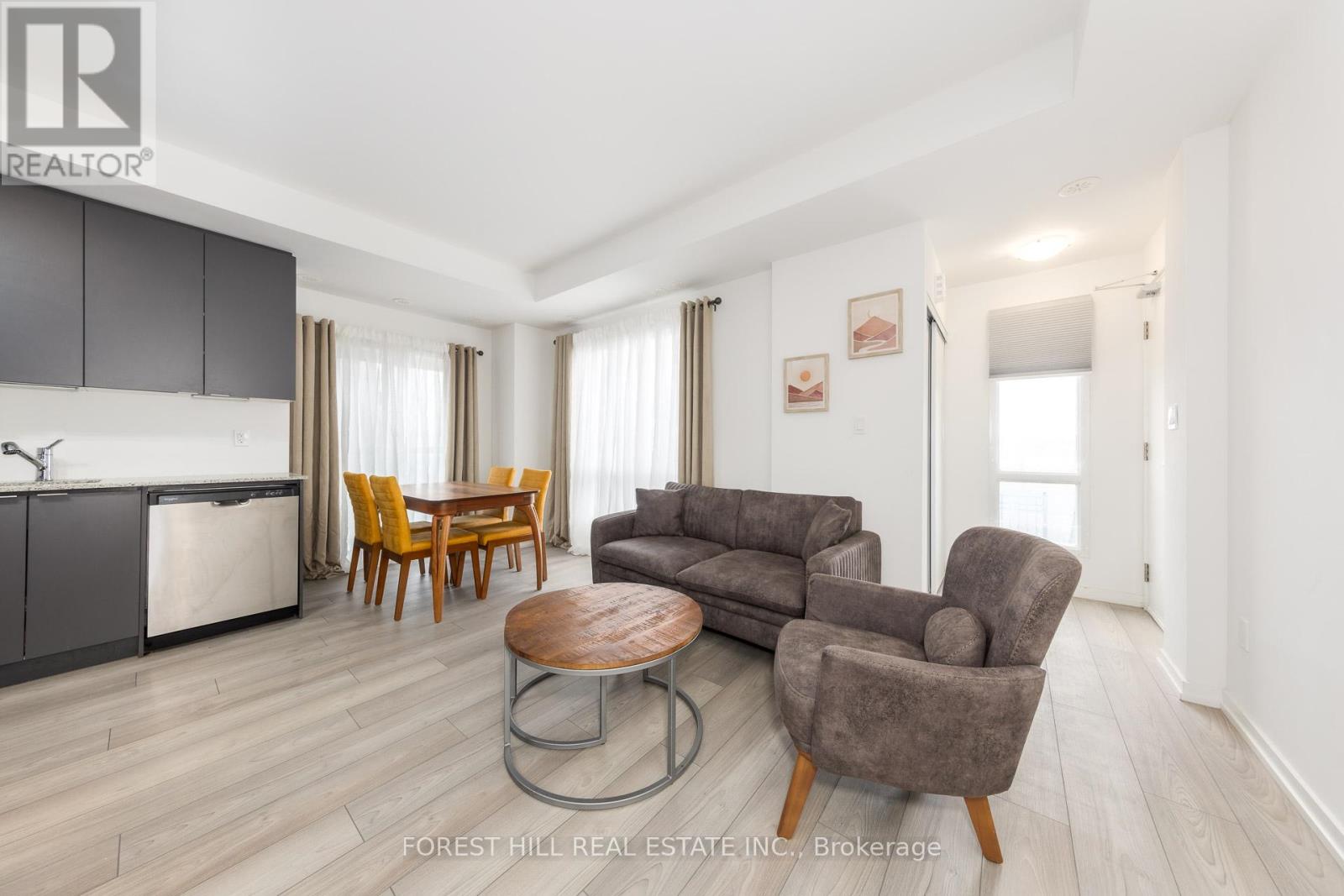 A living room with a brown chair and a brown sofa.