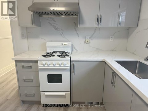 A white stove is on a countertop in a kitchen.