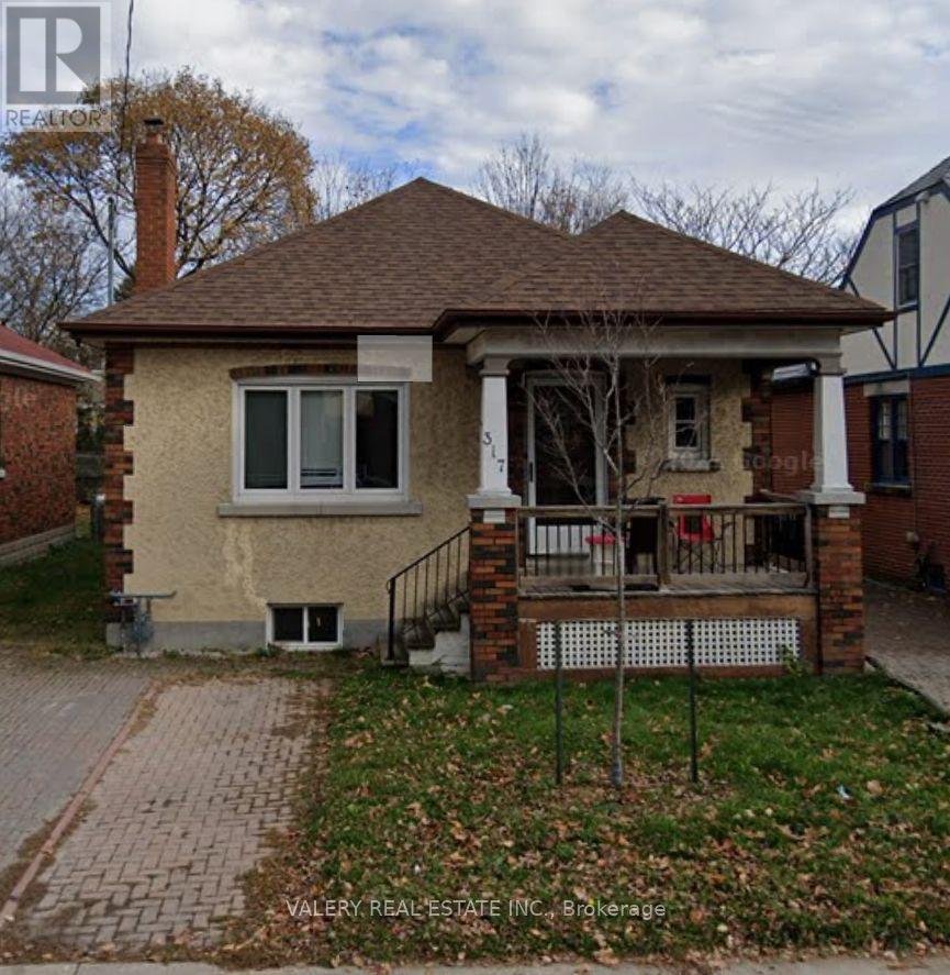 A small house with a brick chimney and a porch.