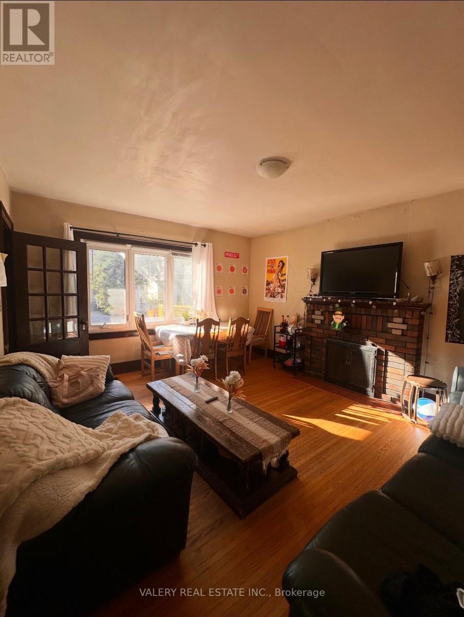 A living room with a couch, a coffee table, and a television.