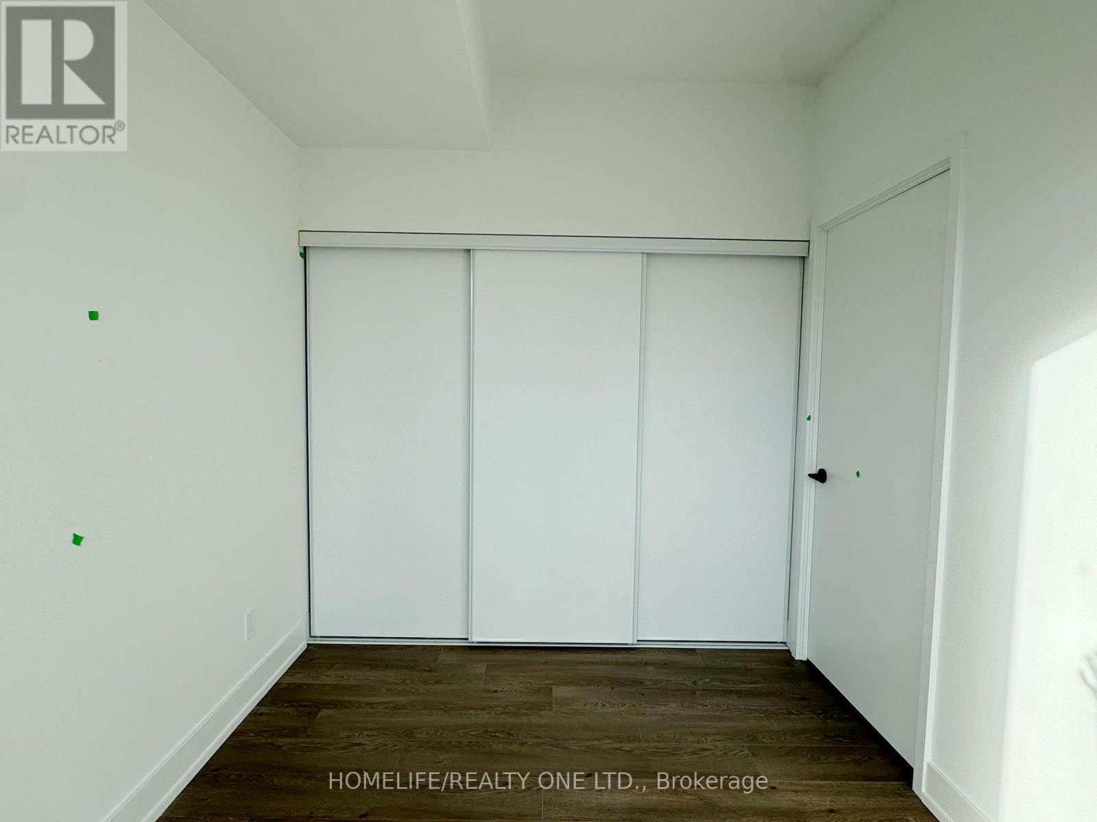 A room with a sliding door and wooden flooring.