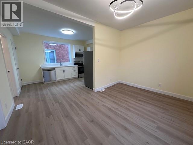 A room with a wooden floor and a window.