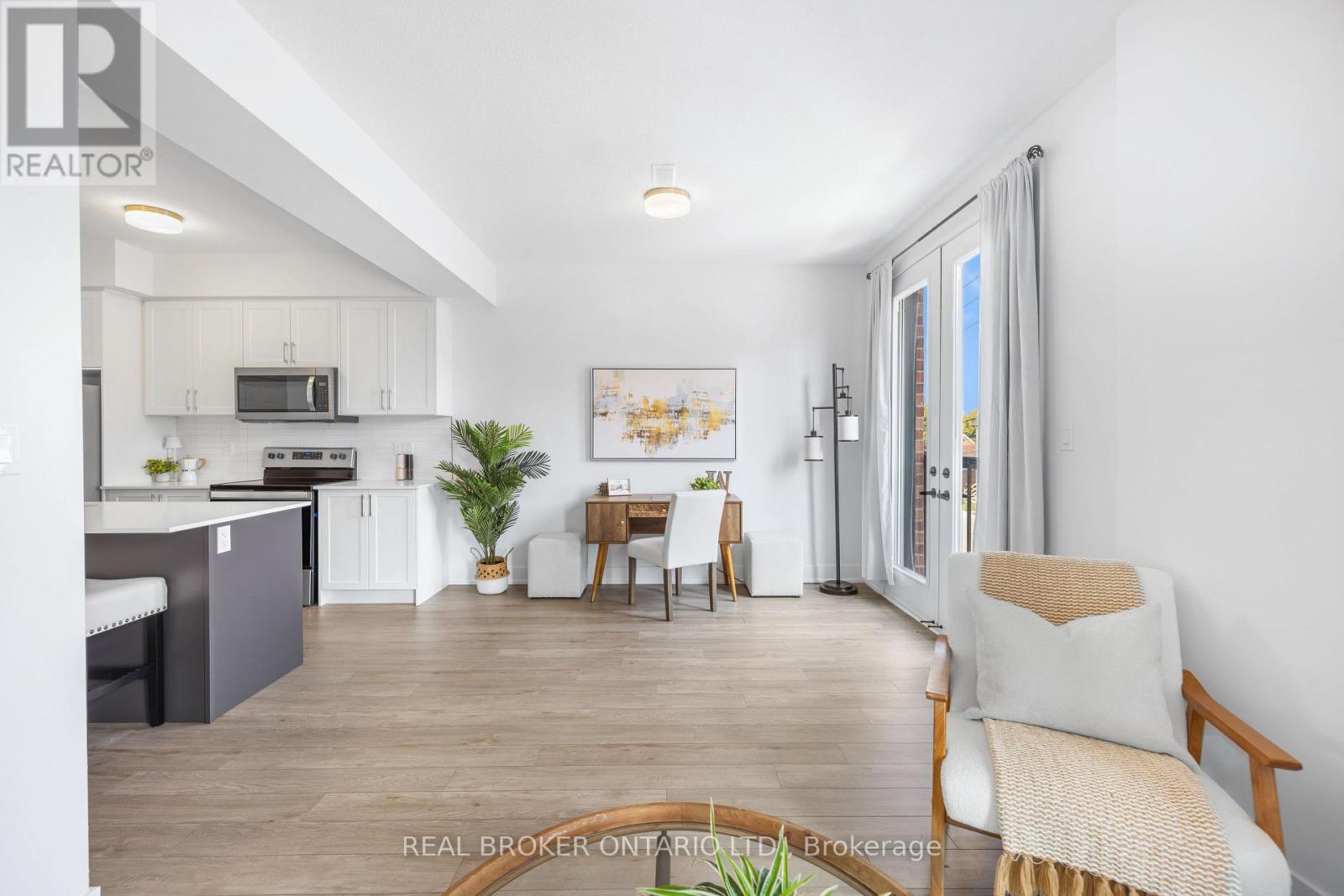 A well-lit, spacious kitchen and living room with modern furnishings.