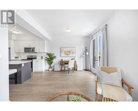 A well-lit, spacious kitchen and living room with modern furnishings.