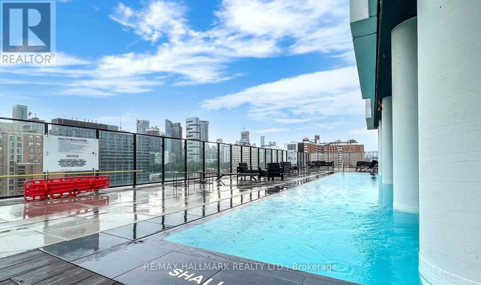 A pool on a balcony with a view of the city.