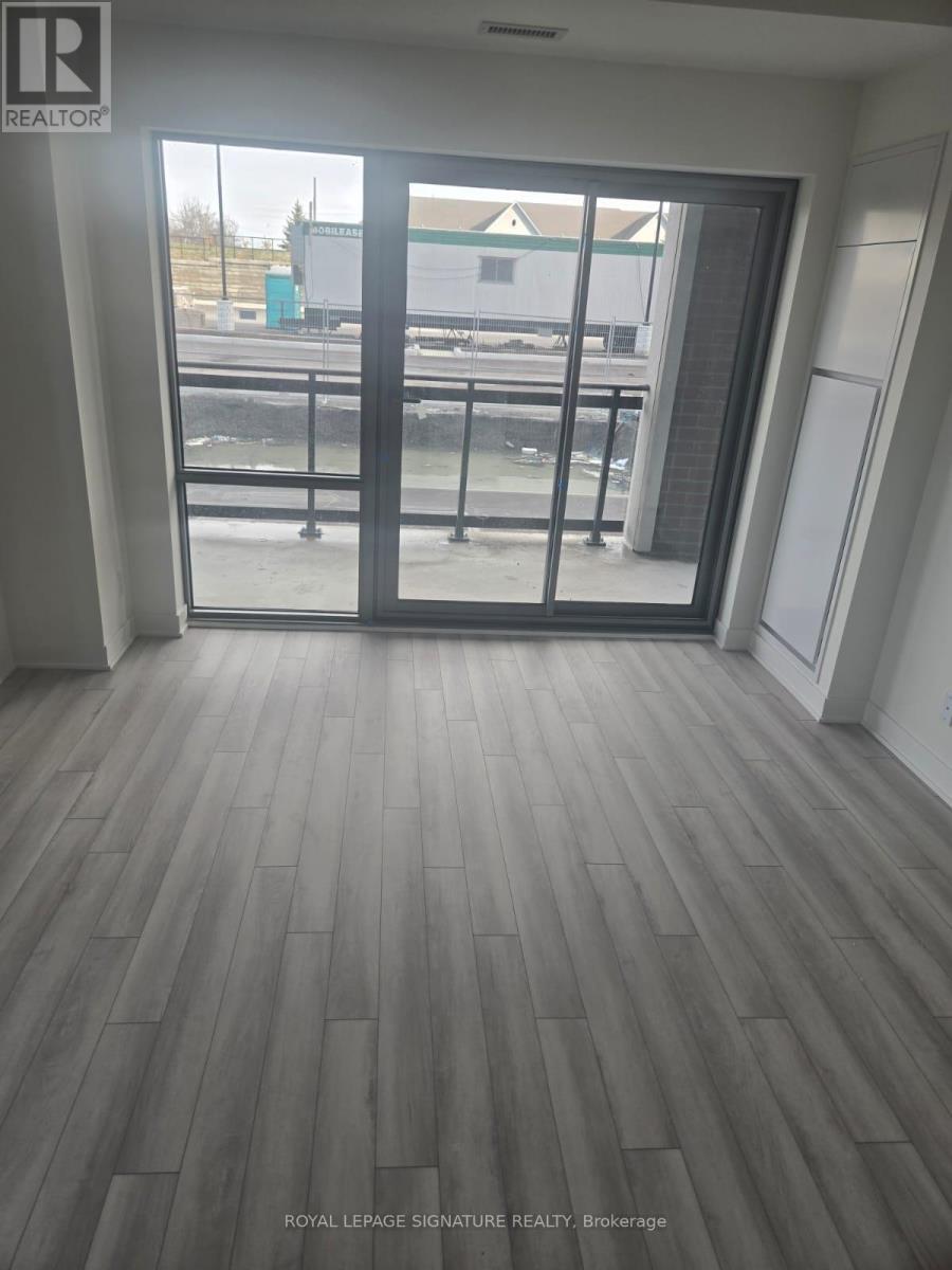 A room with a sliding glass door leading to a balcony.