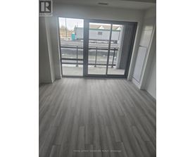 A room with a sliding glass door leading to a balcony.