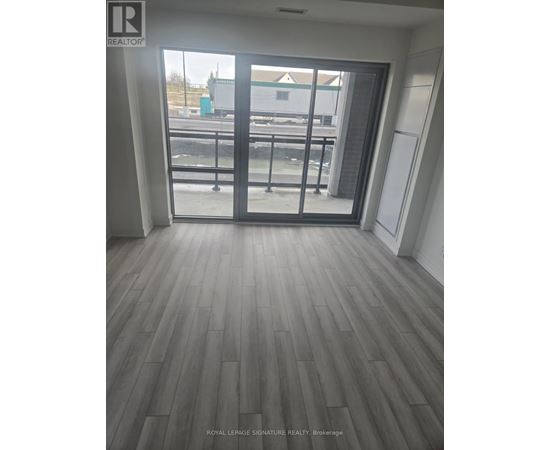 A room with a sliding glass door leading to a balcony.
