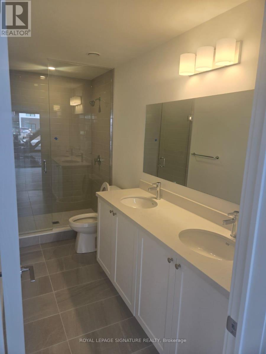 A white bathroom with a sink, toilet and shower.