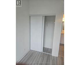 A white sliding door in a room with wooden flooring.