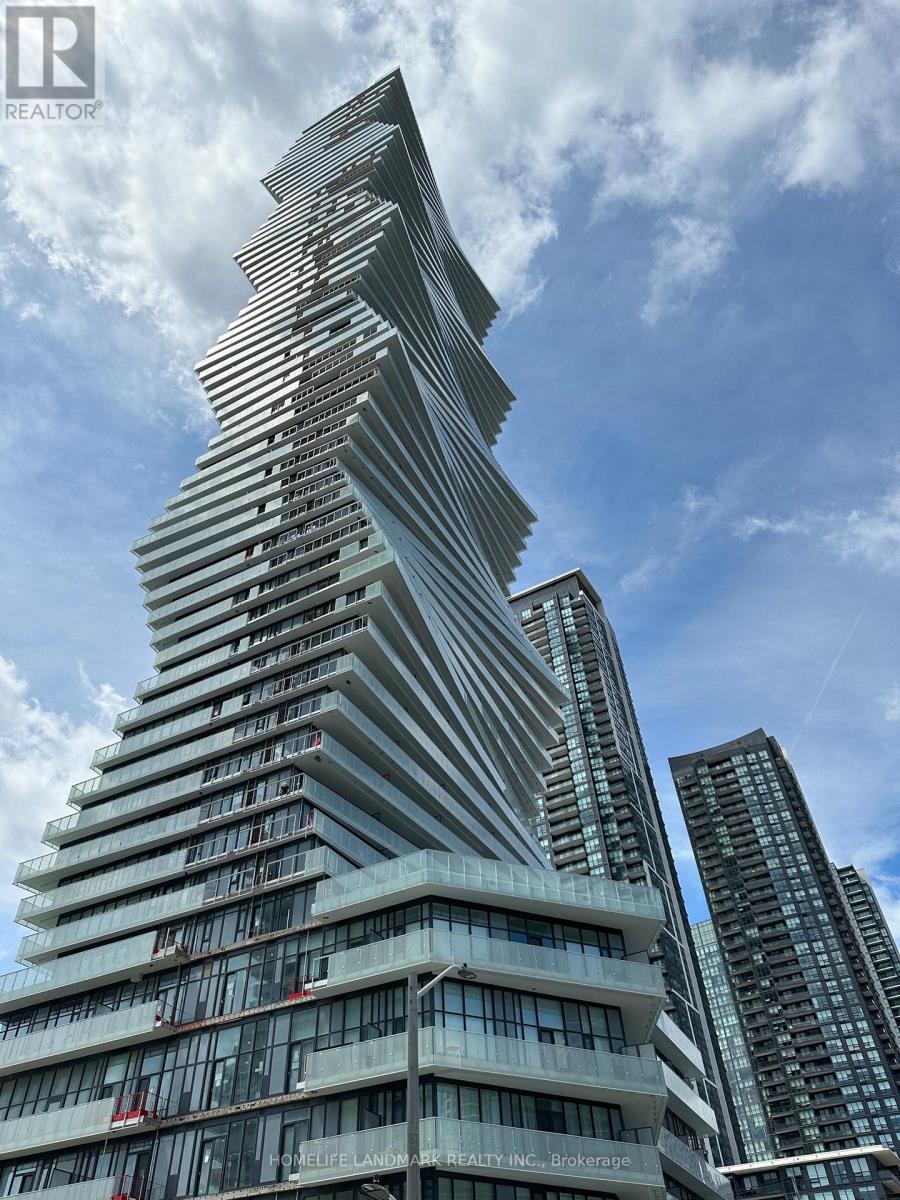 A tall, modern building with a unique design stands out against the sky.