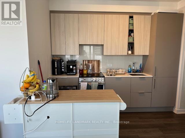 A kitchen with a white cabinet and a wooden counter top.