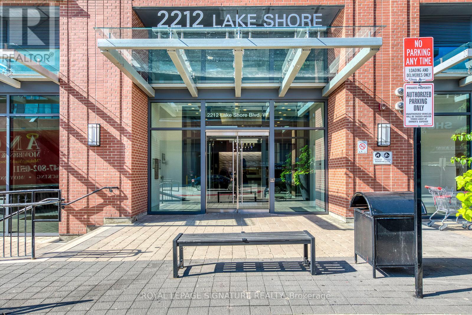 The front of a building with a glass entrance and a sign that says "2212 Lake Shore".