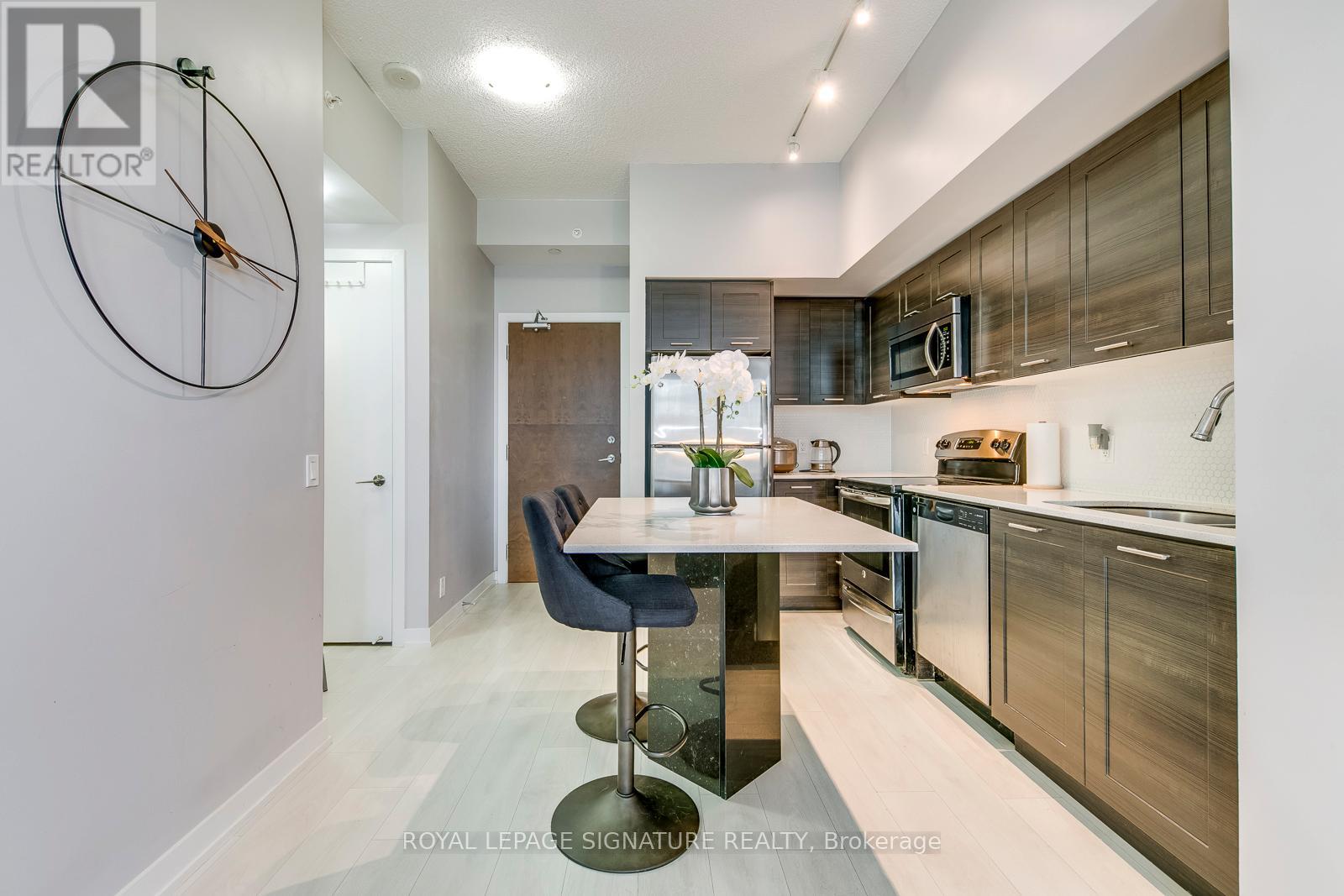 A modern kitchen with a dining table and chairs.