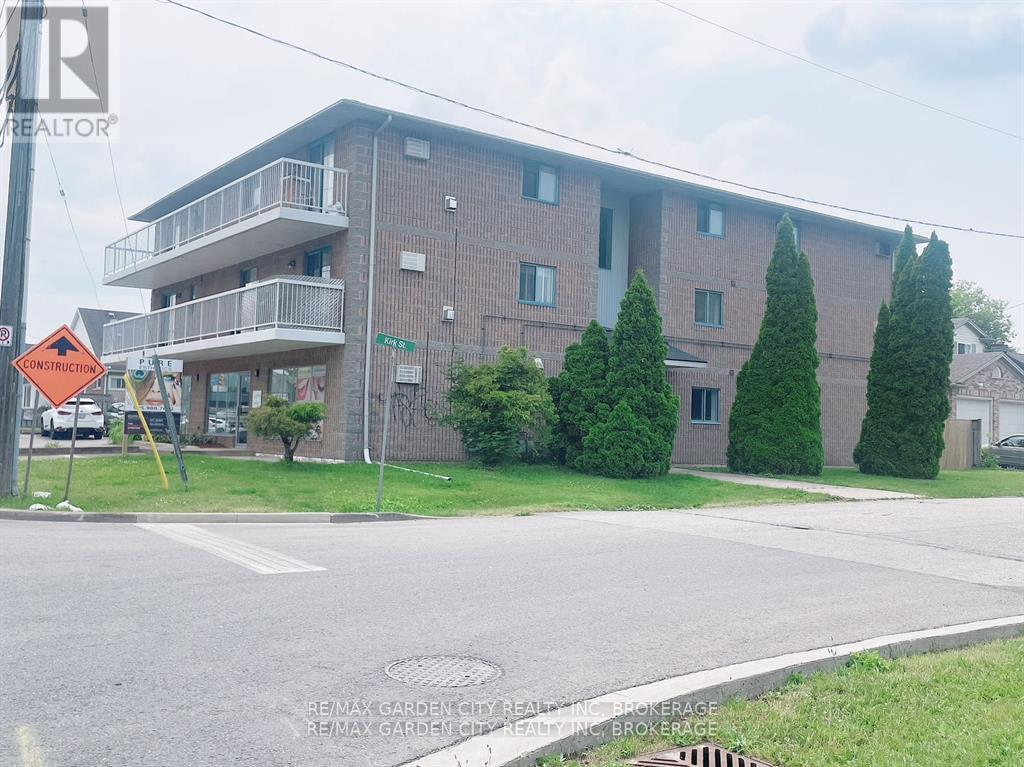 Apartment building with a sign that says RE/MAX Garden City Realty.