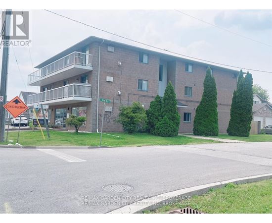 Apartment building with a sign that says RE/MAX Garden City Realty.