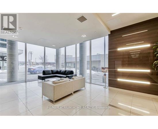A modern living room with a large sectional sofa and a coffee table.