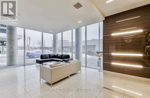 A modern living room with a large sectional sofa and a coffee table.
