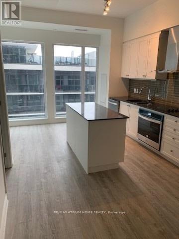 A kitchen with a large island in the middle.