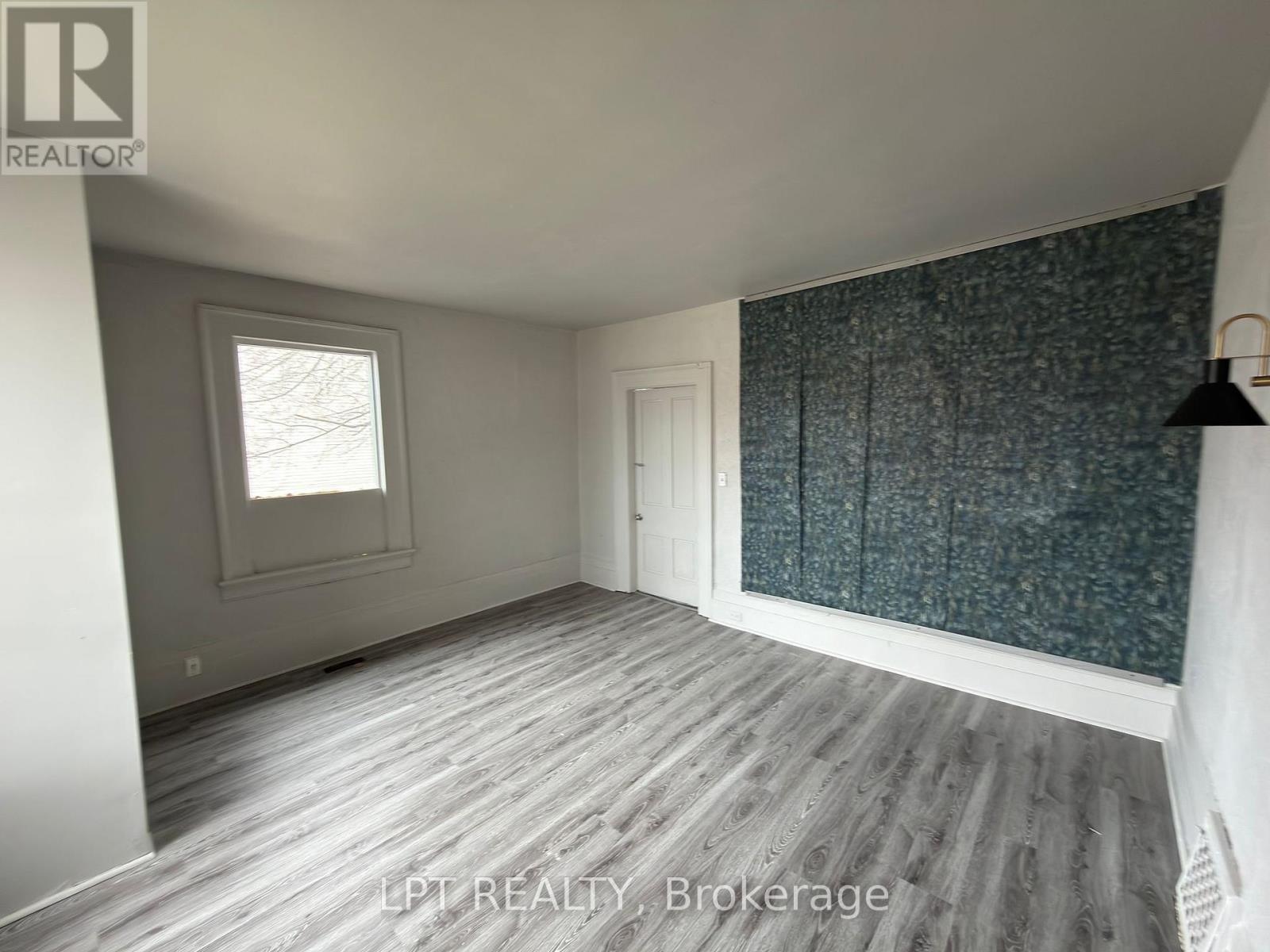 A room with a window and a door is for sale.