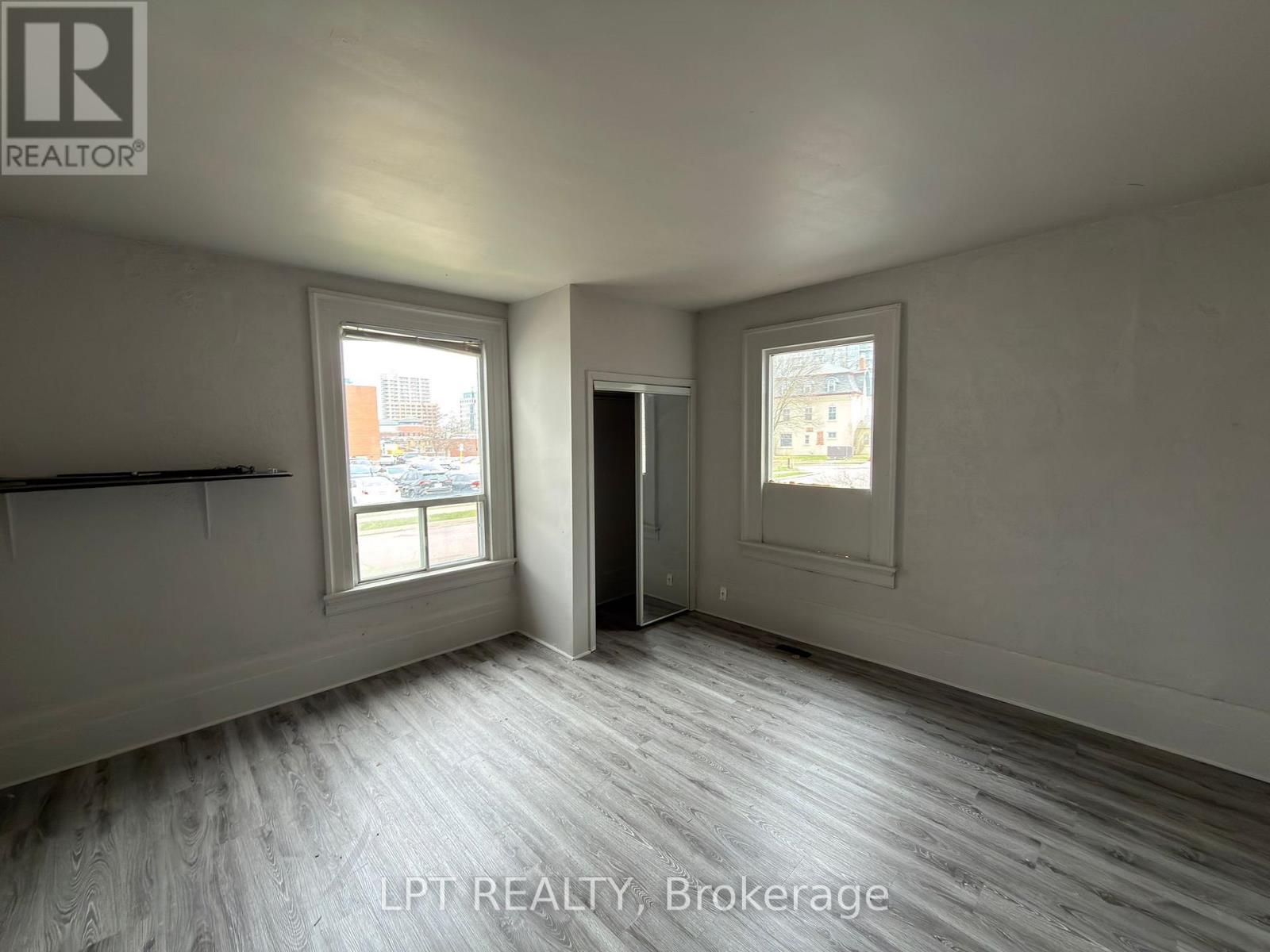 A room with a window and a door is for sale.