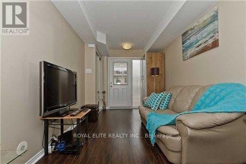 A living room with a couch, television, and a painting on the wall.