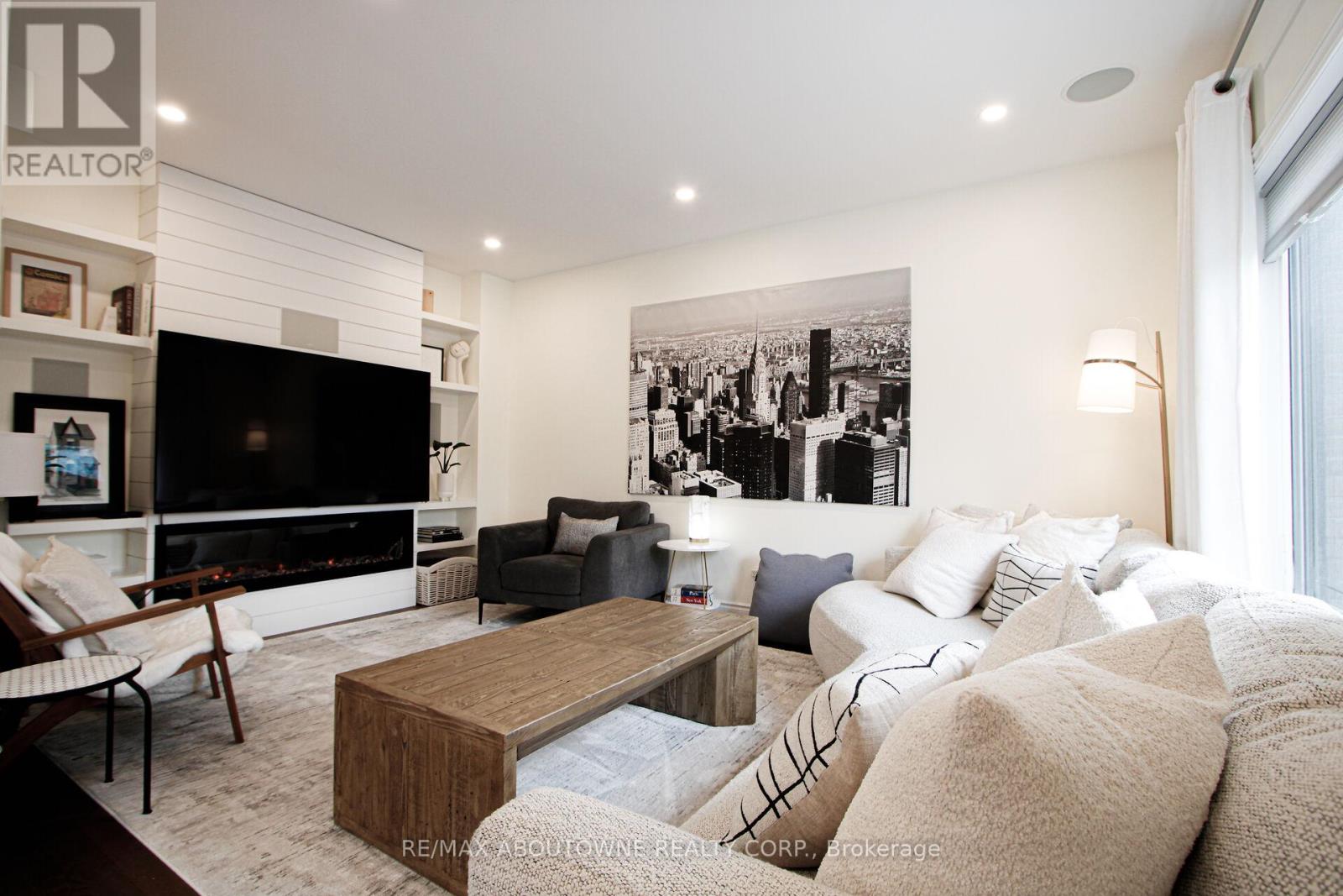 A living room with a large couch and a fireplace.