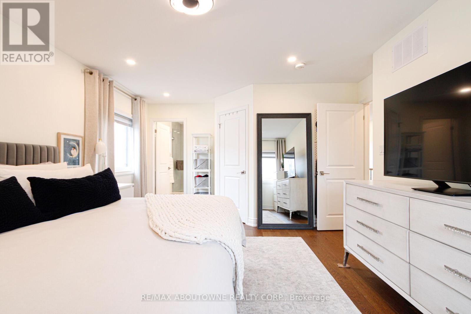 A bedroom with a large bed and a television.