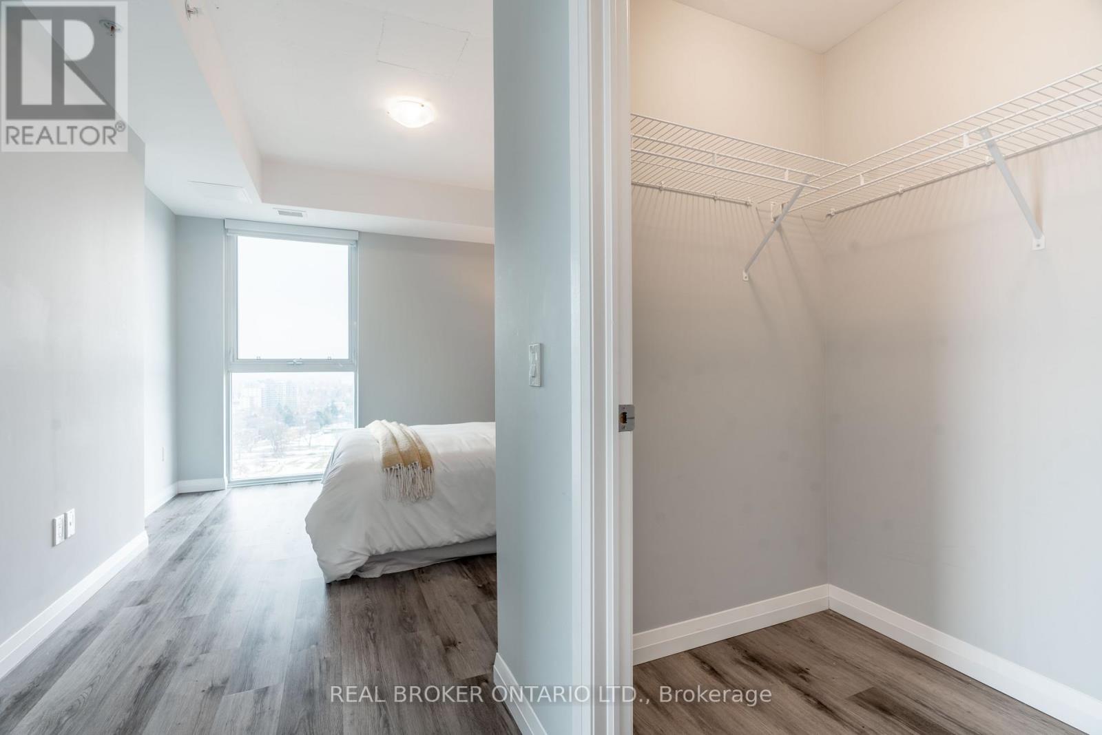 A bedroom with a bed and a closet.