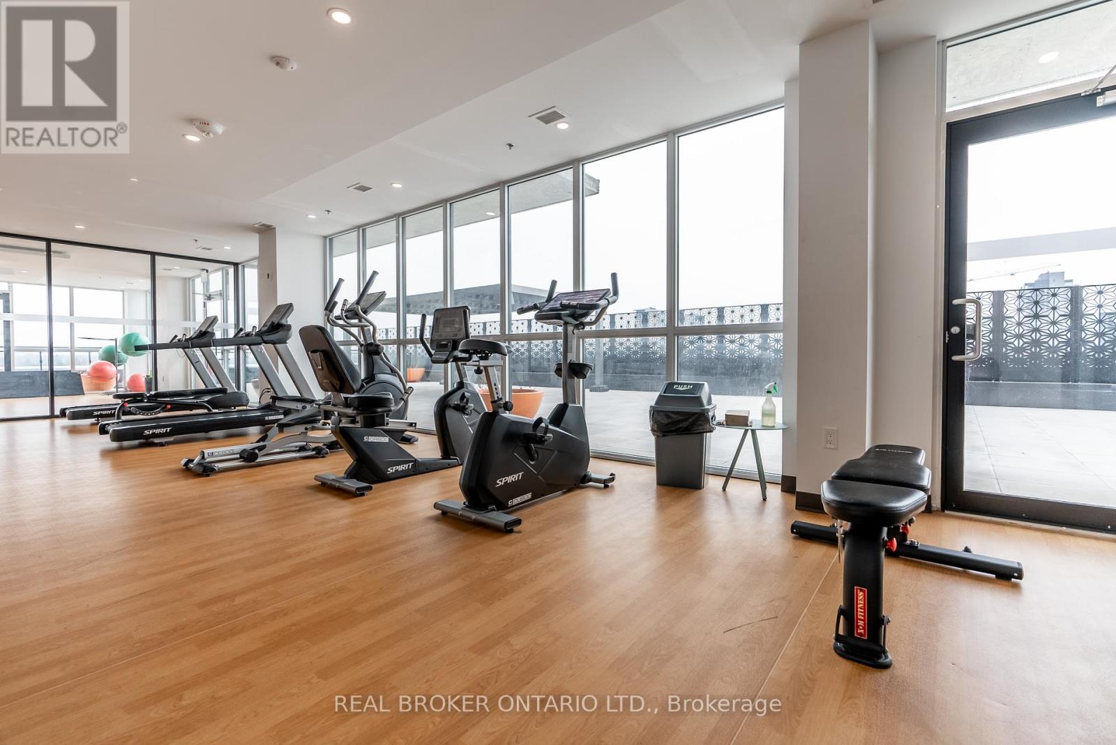 A gym with treadmills, exercise bikes and other equipment.