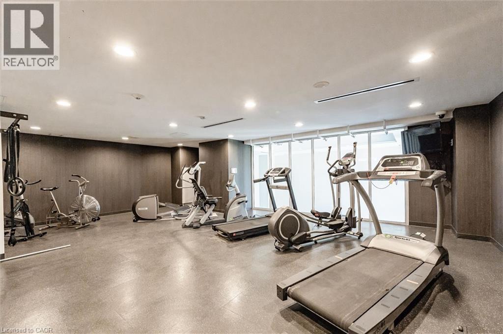 A spacious gym with treadmills, exercise bikes, and other equipment.