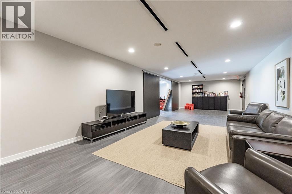 A living room with a grey sofa and a black coffee table.