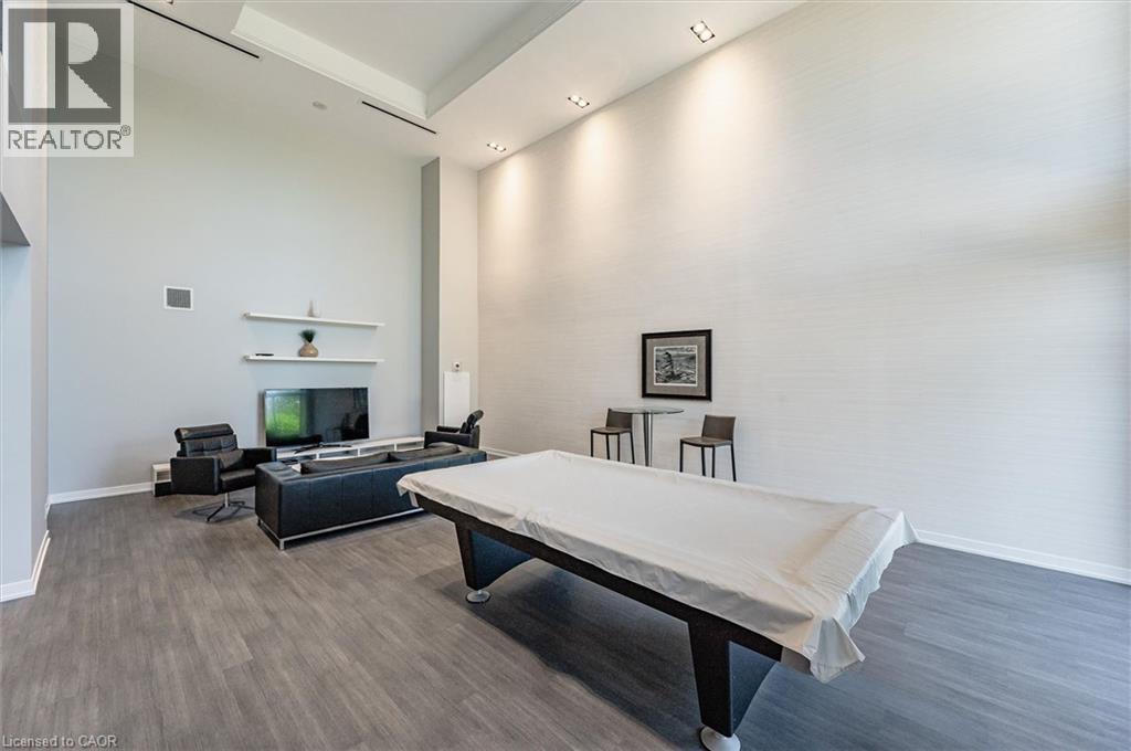 A bedroom with a bed, a couch, a television, and a chair.