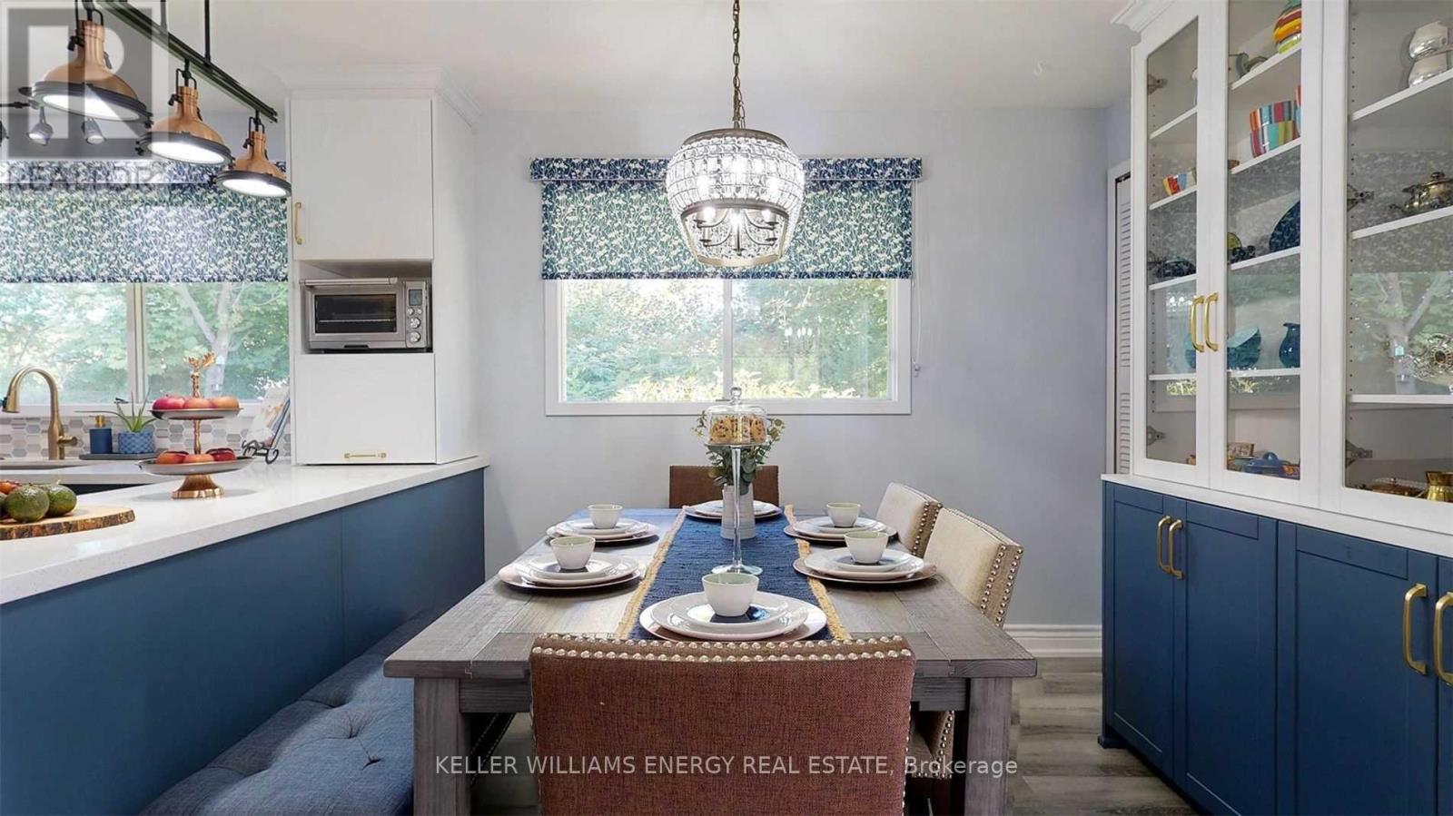 A dining room with a table set for a meal.
