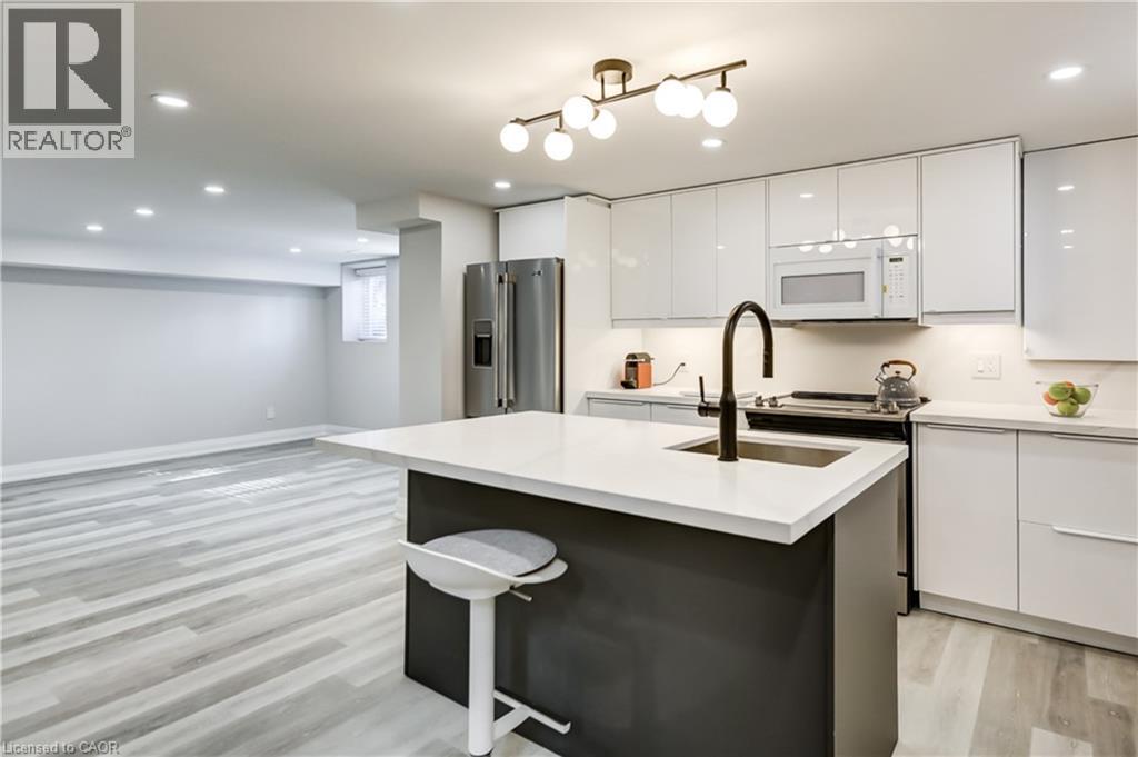 A modern kitchen with white cabinets and a black island.