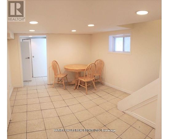 A dining room with a table and chairs.
