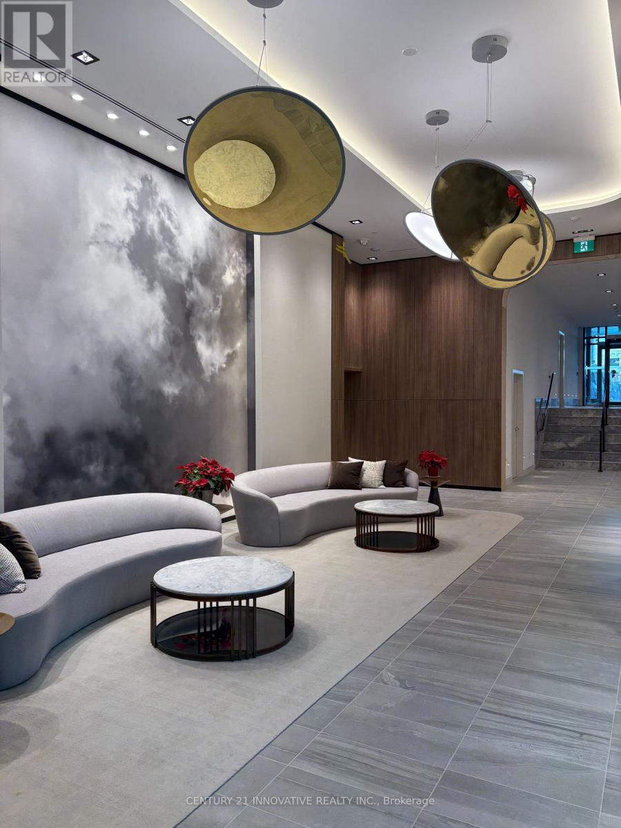 A modern living room with a grey floor and a grey sofa.